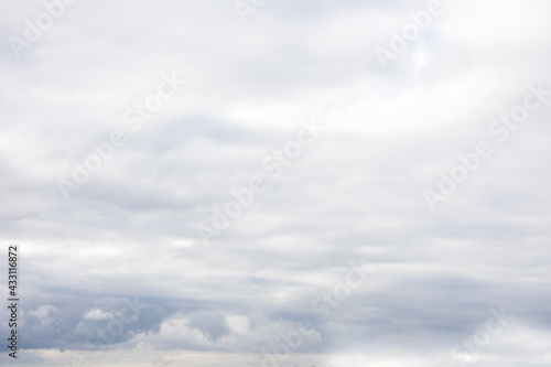 Grey sky with fluffy clouds, abstract background