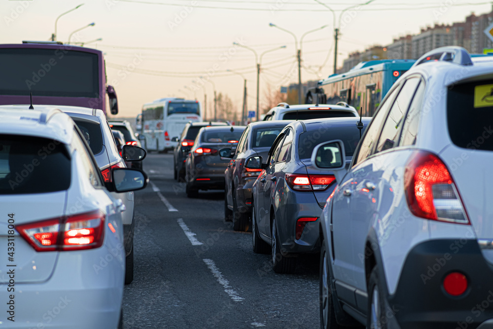 Background, blur, out of focus, bokeh. Traffic jams during rush hours after work. Red brake lights of stopped cars on the background of the city neighborhood.