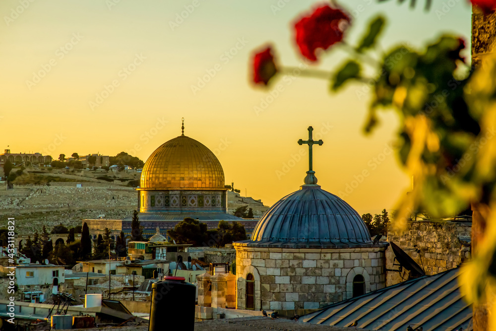 The dome of a Christian church and the dome of the rock in the setting sun, sunset. selective focus
