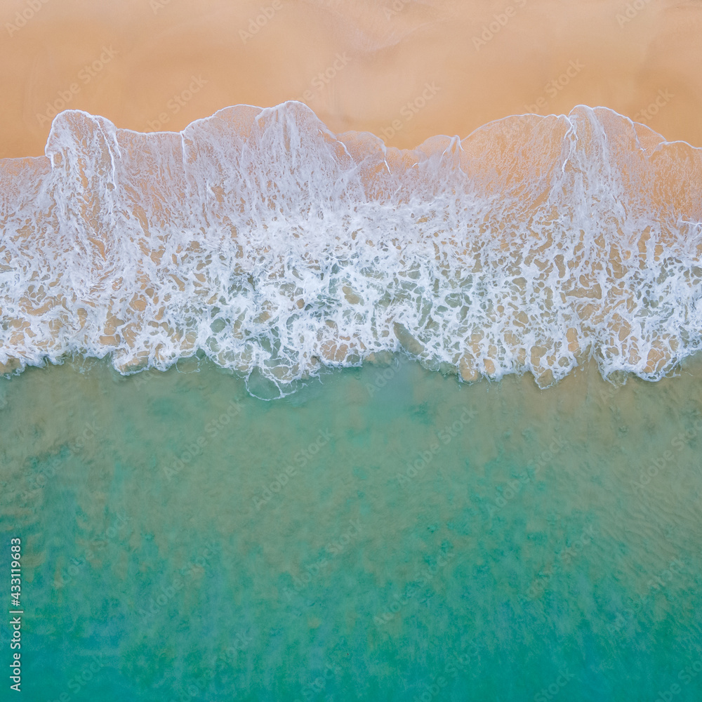 Aerial view of turquoise ocean wave reaching the coastline. Beautiful tropical beach from top view. Andaman sea in Thailand. Summer holiday vacation concept Aerial view of turquoise ocean wave reaching the coastline. Beautiful tropical beach from top view. Andaman sea in Thailand. Summer holiday vacation concept