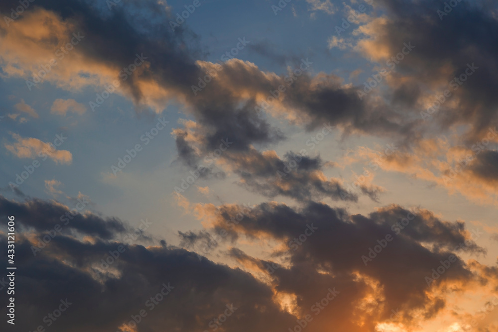 Evening sunset, sky above the clouds with dramatic yellow light.