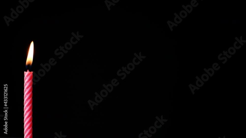birthday candles light on isolated black. Place for text