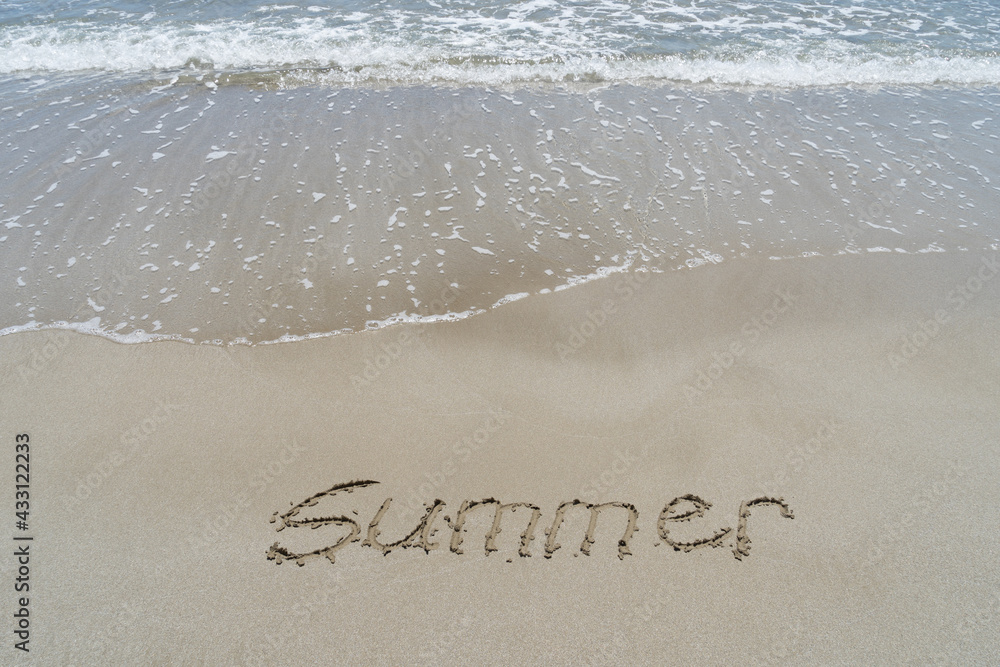 Fototapeta premium summer written in fine sand on the beach