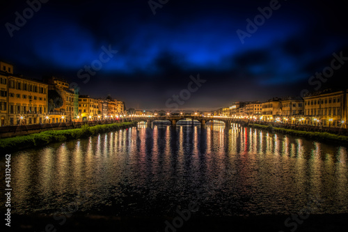 Reflection in the water of the Arno River in Florence, Italy, at night © Lowell