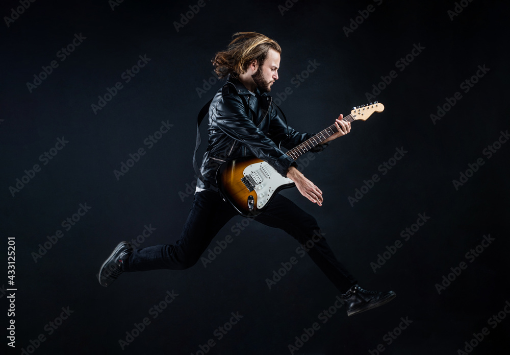 musician guitar player jumping. playing rock music. stylish crazy man. string musical instrument. musician guitar player jumping. playing rock music. stylish crazy man. string musical instrument.