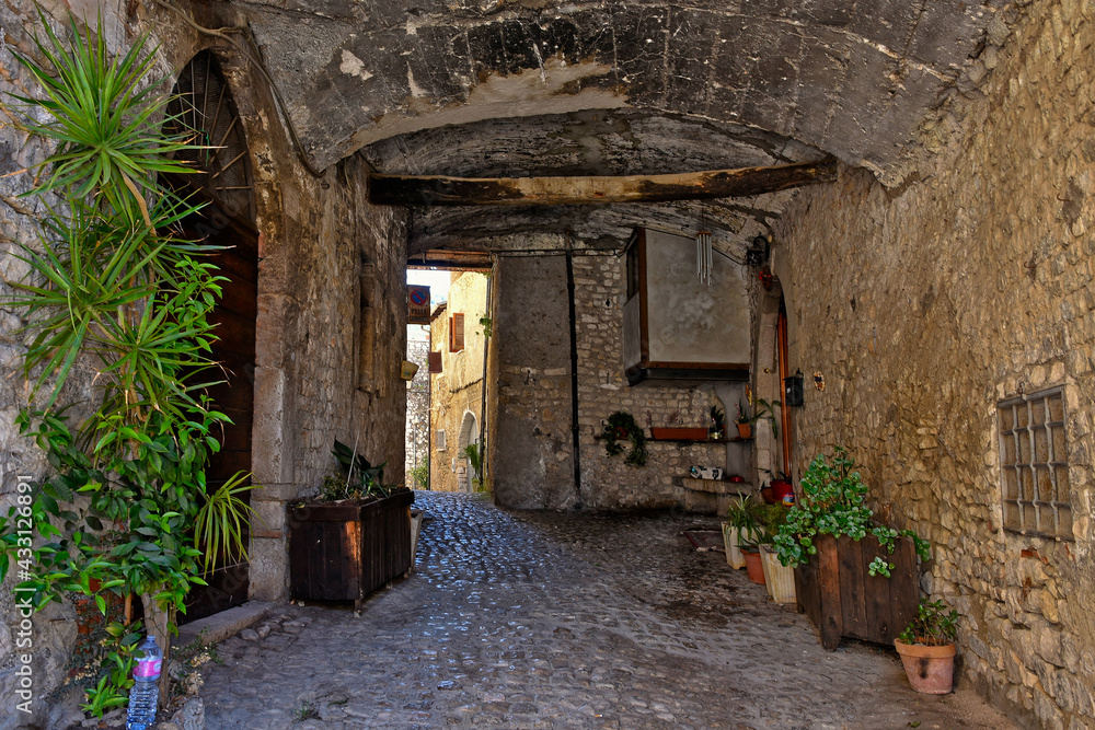 Sermoneta, Italy, 05/10/2021. A street between old medieval stone buildings in the historic town. Sermoneta, Italy, 05/10/2021. A street between old medieval stone buildings in the historic town.