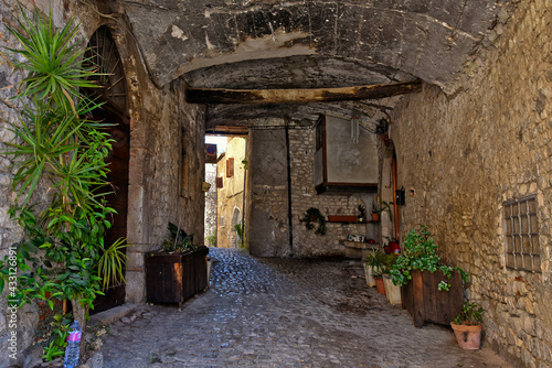 Sermoneta, Italy, 05/10/2021. A street between old medieval stone buildings in the historic town.