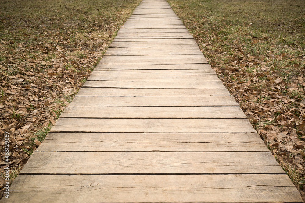 Wooden path way go through harvested field Wooden path way go through harvested field
