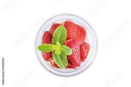 Oatmeal porridge with milk and fresh strawberries in a glass on a white isolated background