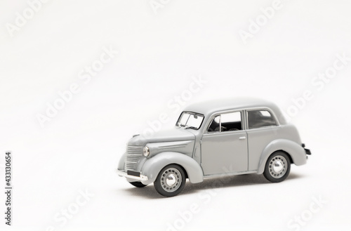 Miniature model of a retro car on a white background. A toy car model. Vintage car model.  