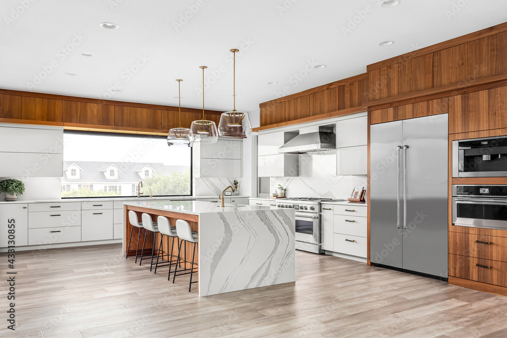 Beautiful kitchen in new luxury home with large waterfall island ...