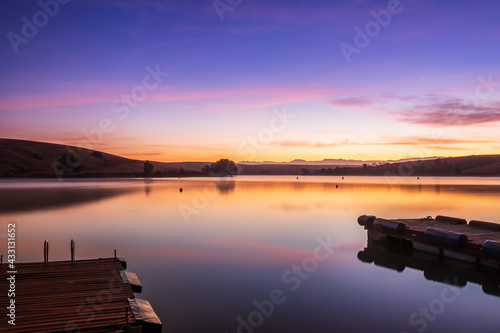 Sunrise view of a still, silent dam with boat jetty’s in the foreground,  Club Elani Resort, Cape Town, South Africa photo