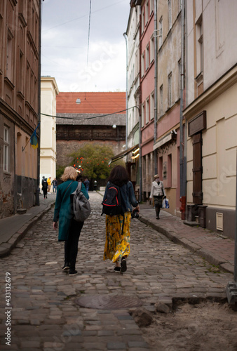 Two women walk in the old city of Lviv