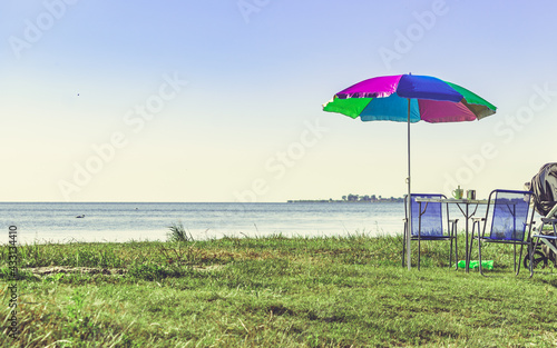 Picnic on beach. Umbrella with chairs