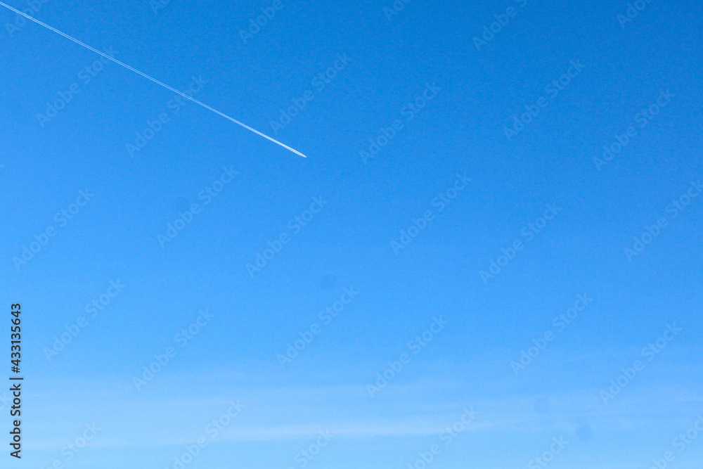 Clear blue sky with slightly visible plane exhaust . Idea for summer spring background Clear blue sky with slightly visible plane exhaust . Idea for summer spring background