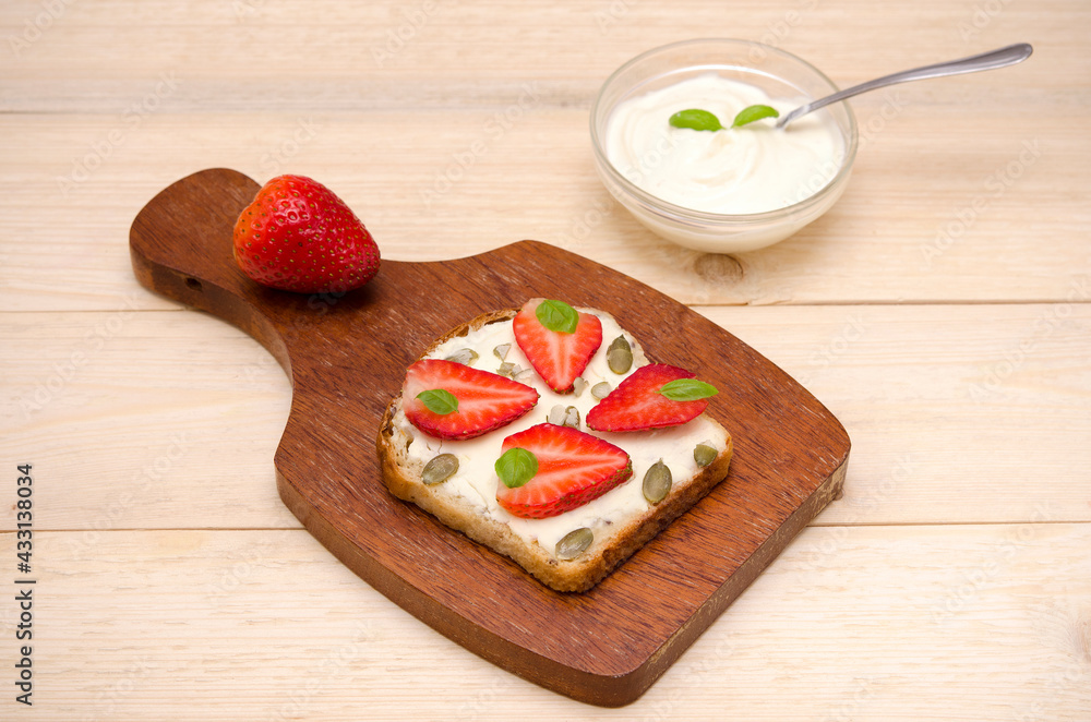 vegetarian sweet toast with cheese and strawberries and cream on the table
