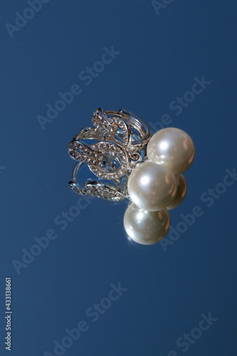 pearl earrings on blue background