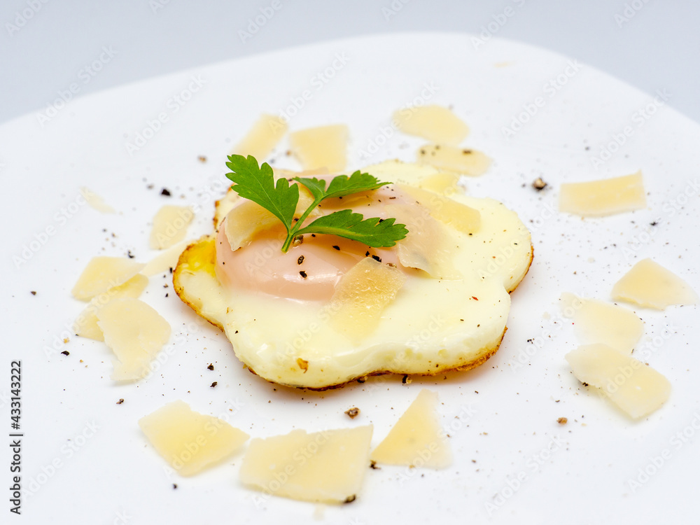flower head shape cooked egg served with cheese flakes on top