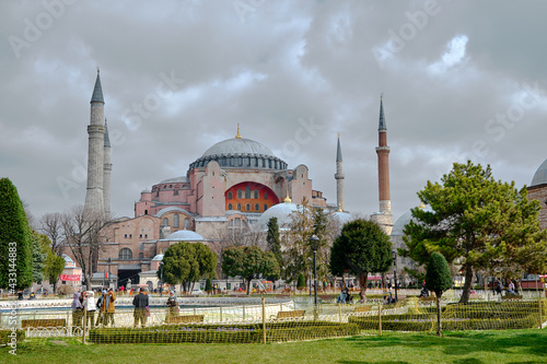 Overcast and cloudscape above the hagia sophia. Ancient hagia sophia mosque by taking photo from Sultanahmet square and green grass with many people and tourist walking. . istanbul. Turkey.
