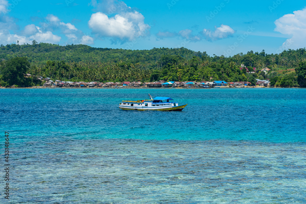 Islanders and tourists travel from island to island by slow boat in the Togian Islands. The ferry from Ampana connects the mainland with the main towns of Bomba to Wakai Islanders and tourists travel from island to island by slow boat in the Togian Islands. The ferry from Ampana connects the mainland with the main towns of Bomba to Wakai