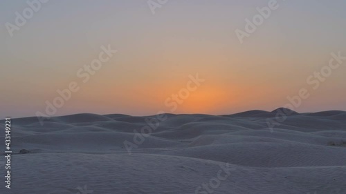 Sand dunes of the Sahara Desert against the backdrop of the sunset sky