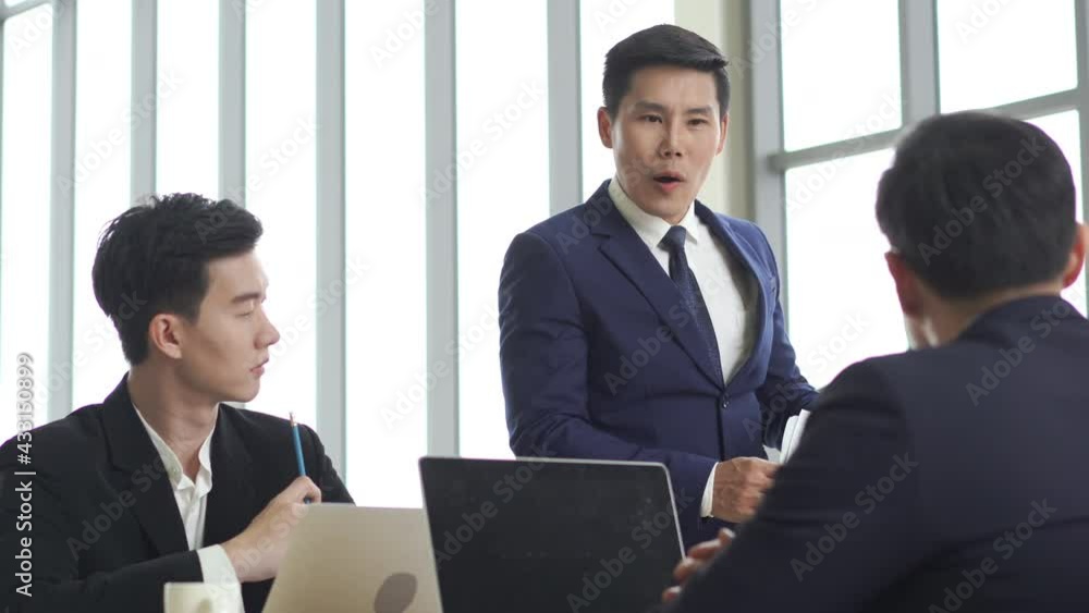 Group of Asian businessman and businesswoman colleague meeting and brainstorming strategy ideas for success business project. Business people male manager briefing work plan in office conference room Group of Asian businessman and businesswoman colleague meeting and brainstorming strategy ideas for success business project. Business people male manager briefing work plan in office conference room
