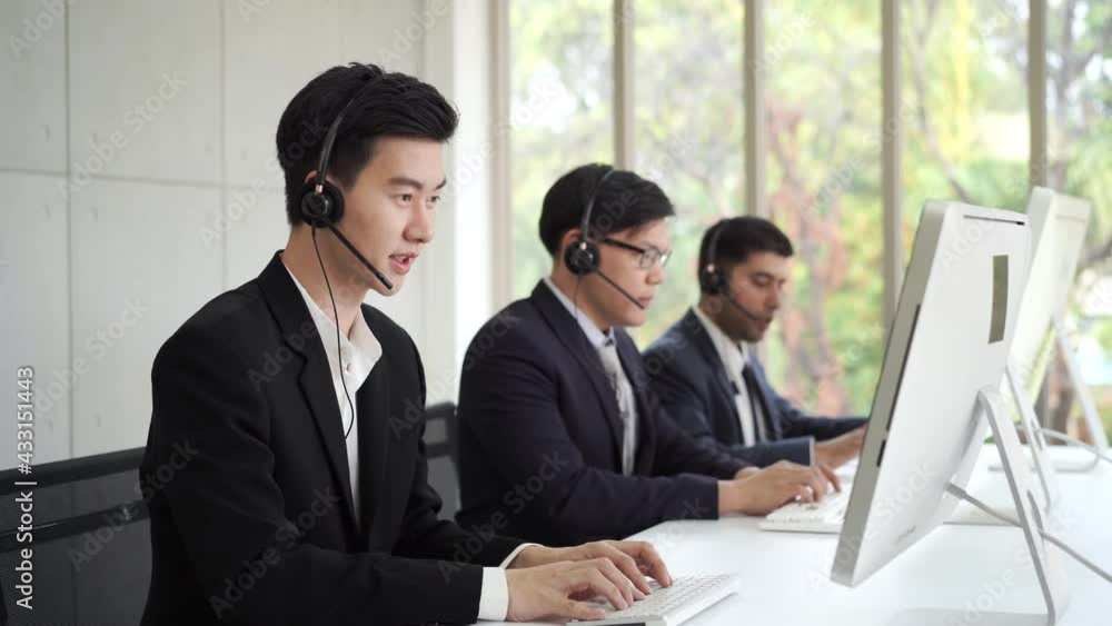 Diversity male customer service call center helpdesk team wearing headset speaking video call for online consulting and support client. Businessman working telesales marketing communication in office. Diversity male customer service call center helpdesk team wearing headset speaking video call for online consulting and support client. Businessman working telesales marketing communication in office.