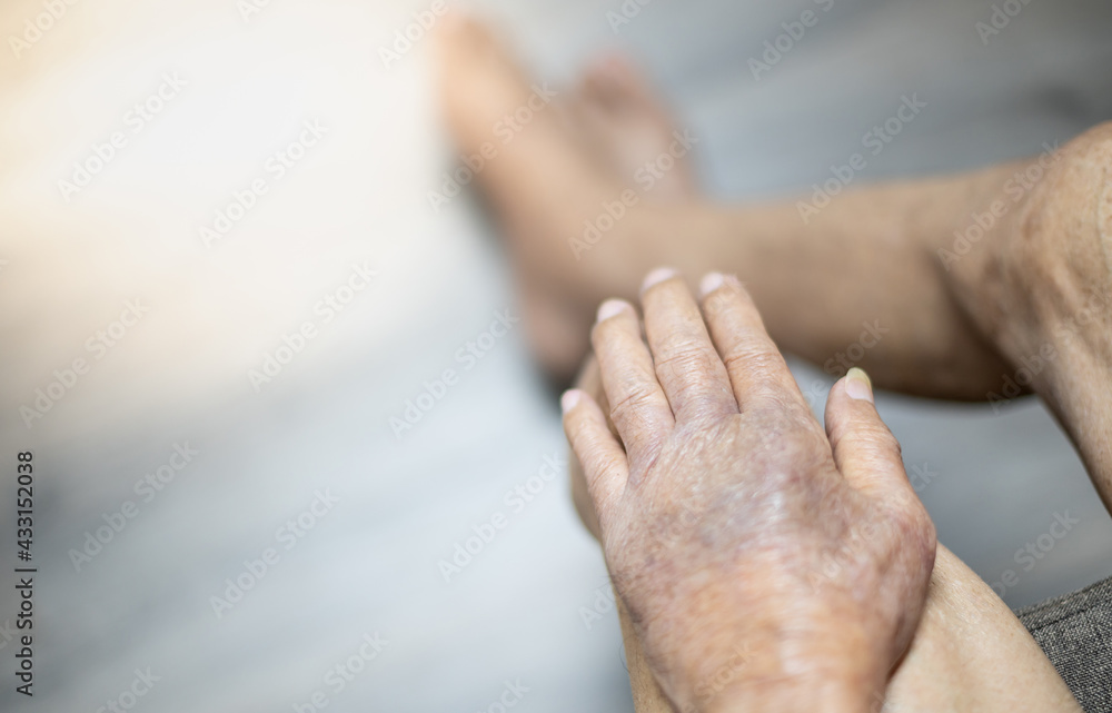 Fototapeta premium The hand of old man with the wrinkled hand and bruised from the body lack of nutrition protein.