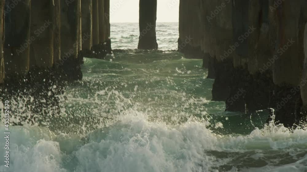 custom made wallpaper toronto digitalSuper slow motion of water splashes breaking off the pier pillars. Ocean droplets highlighted in sunset summer light. Seascape background. Shot on RED helium weapon cinema camera.