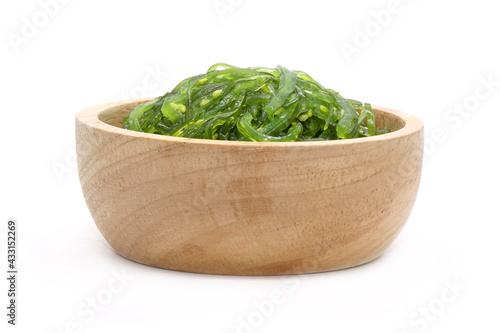 Chuka Wakame Salad in wooden bowl isolated on white background. Famous Japanese appetizer