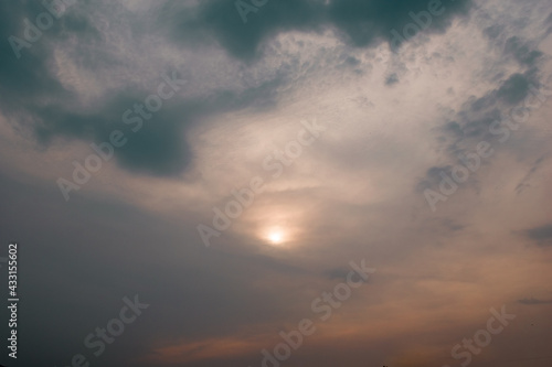 Evening picture of Sun after thunderstorm. dark and orange clouds together