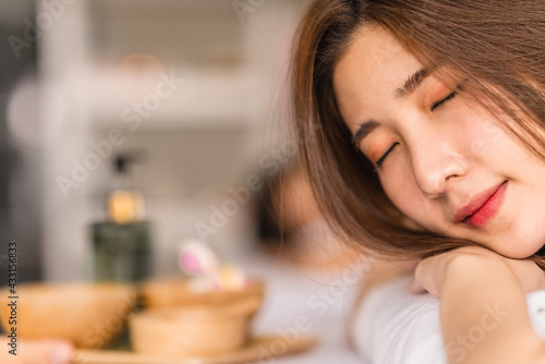 asian young woman lying on bed for spa treatmentin spa salon