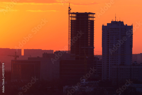 Dawn in Vladivostok. Silhouettes Two residential buildings under construction during a bright dawn.