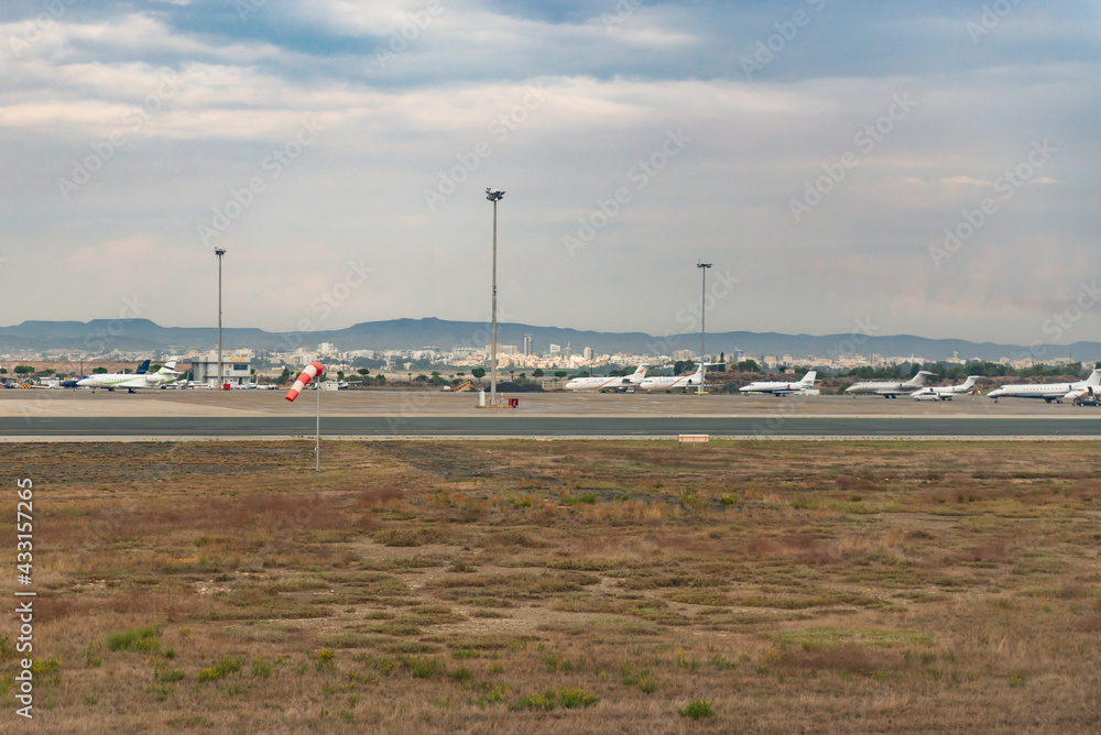 Paphos Airport in Cyprus. Planes on the runway and at the hangars. Taxiway to the airport terminals. One plane at many airports. Paphos Airport in Cyprus. Planes on the runway and at the hangars. Taxiway to the airport terminals. One plane at many airports.