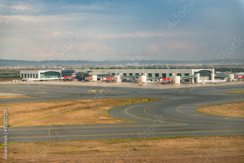 Paphos Airport in Cyprus. Planes on the runway and at the hangars. Taxiway to the airport terminals. One plane at many airports.