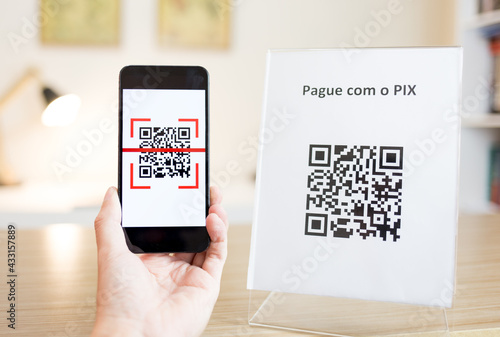 Konstfotografi Reading a QR Code with smartphone to make a payment or transfer money via PIX