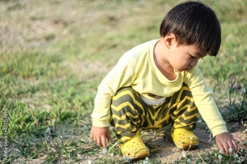 a boy playing in the grass