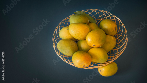 mangoes in basket blue dark background Mango fruits Top view photo