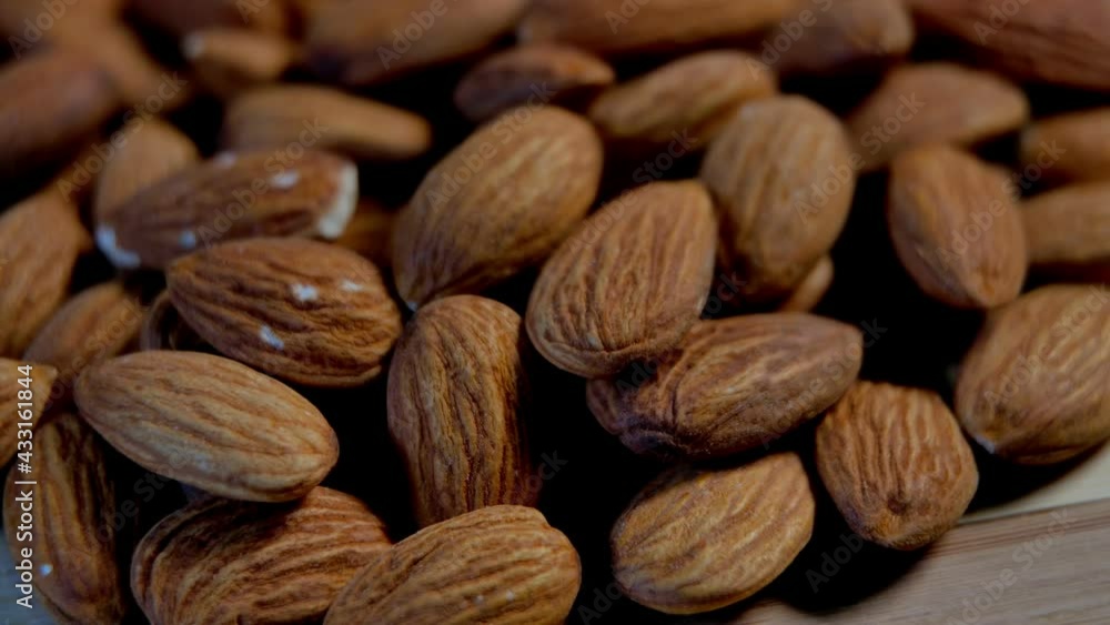 Nut almond close up. product rich in minerals and vitamins. Slow motion closeup roasted almond Nut almond close up. product rich in minerals and vitamins. Slow motion closeup roasted almond