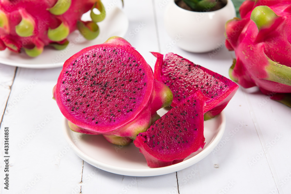 dragon fruit with half on white wood background dragon fruit with half on white wood background
