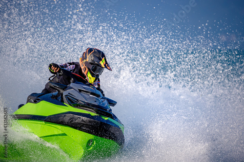 Fotografi A man driving a jet ski
