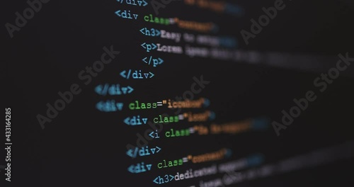 4K Close up shot HTML tag code on PC Monitor scroll down. Background concept for programming and coding web development. photo