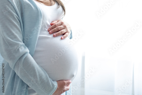 healthy pregnancy. Side view pregnant woman with big belly advanced pregnancy in hands. Banner copyspace for text. Elegant mother waiting baby photo