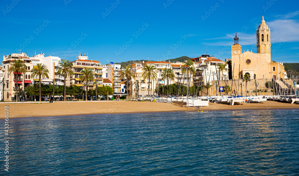 photo of beach with church in Sites in Catalonia.