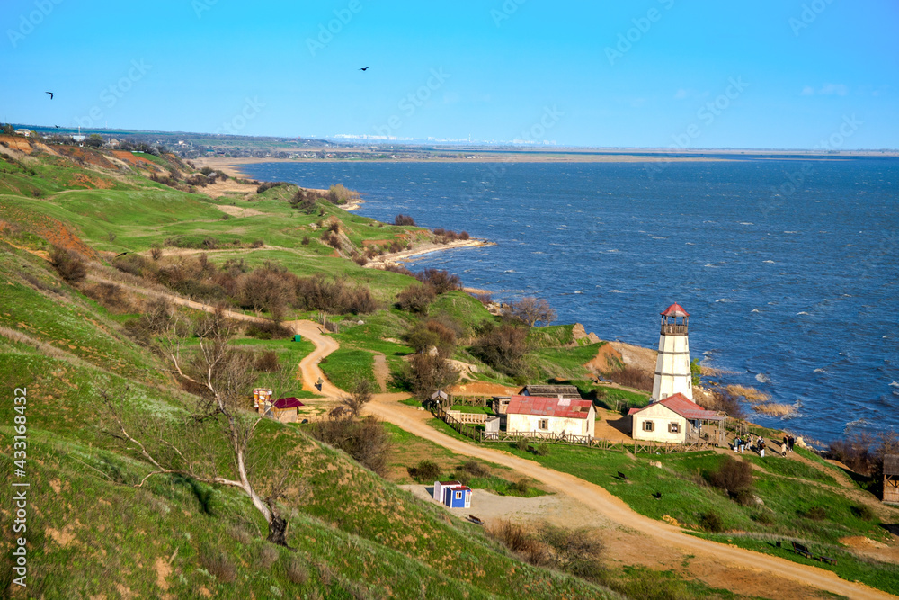 Landscape, sea and lighthouse. Spring at sea