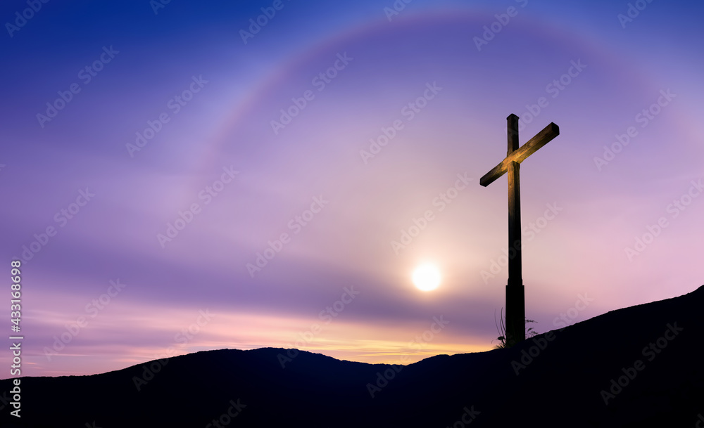 Christian cross at sunrise or sunset concept of religion