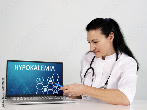  HYPOKALEMIA text in menu. Neurologist looking for something at laptop photo