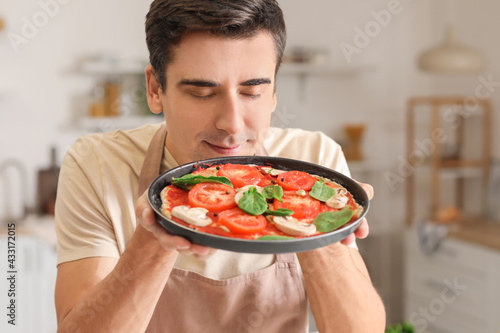 Young man with tasty pizza ...