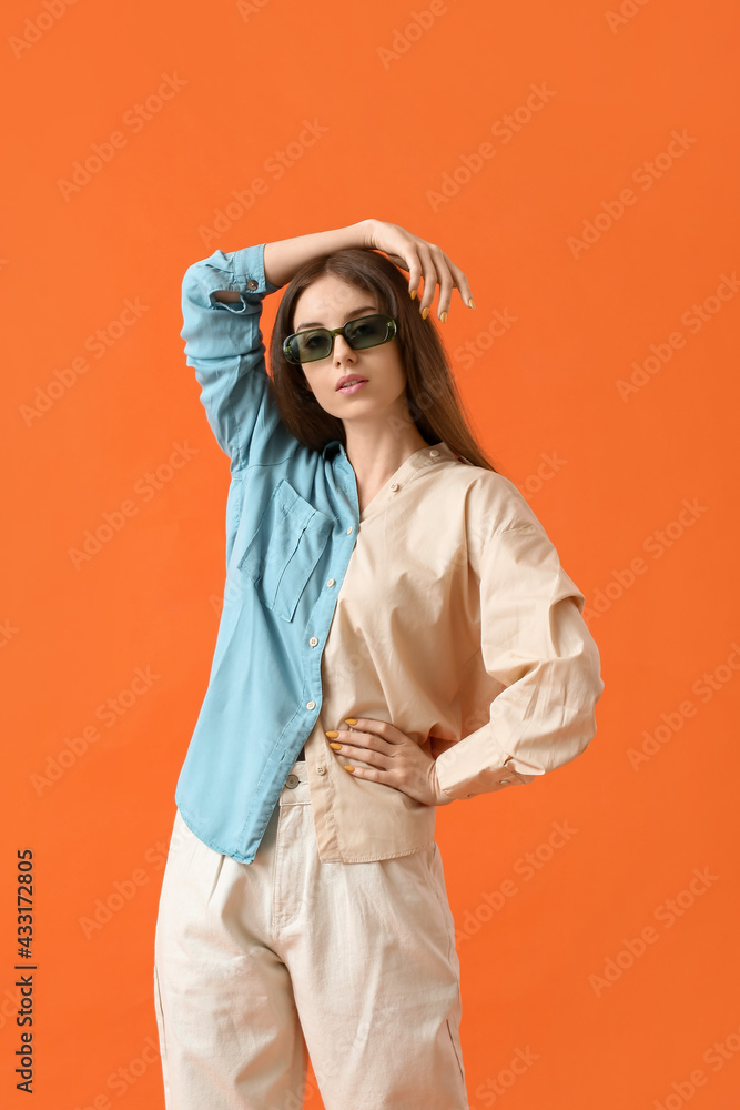 Beautiful young woman with stylish sunglasses on color background Beautiful young woman with stylish sunglasses on color background