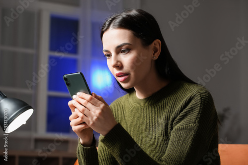 Young woman with mobile pho...